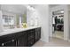 Bathroom features a dual sink vanity with a walk in closet nearby at 7315 Blue Water Dr, Castle Rock, CO 80108