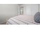 Bedroom featuring neutral walls, carpet, and a bed with red patterned bedding at 7315 Blue Water Dr, Castle Rock, CO 80108