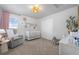 Comfortable bedroom with a glider, crib, and natural light at 7315 Blue Water Dr, Castle Rock, CO 80108