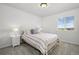 Bright bedroom with a white metal frame bed, side tables and a large window at 7315 Blue Water Dr, Castle Rock, CO 80108