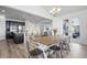Open-concept dining area adjacent to kitchen, featuring a wood table, metal chairs, and hardwood floors at 7315 Blue Water Dr, Castle Rock, CO 80108