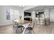 Dining space showcasing a wooden table set with metal chairs, set in a sunlit area with a kitchen view at 7315 Blue Water Dr, Castle Rock, CO 80108