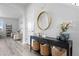 Stylish entryway featuring a modern console table with decorative baskets and a round mirror at 7315 Blue Water Dr, Castle Rock, CO 80108
