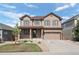 Charming two-story home with a well-manicured lawn, covered porch, and attached two-car garage at 7315 Blue Water Dr, Castle Rock, CO 80108