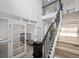 Elegant foyer with high ceilings, wood stairs, and a glass-enclosed office space at 7315 Blue Water Dr, Castle Rock, CO 80108