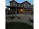 Exterior of home with a well maintained lawn, and decorative lighting at 7315 Blue Water Dr, Castle Rock, CO 80108