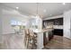 Modern kitchen featuring a spacious island with seating, pendant lighting, and dark cabinetry at 7315 Blue Water Dr, Castle Rock, CO 80108