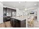 Open kitchen with granite island, stainless steel appliances, oven, and hardwood floors at 7315 Blue Water Dr, Castle Rock, CO 80108