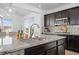 Modern kitchen with granite countertops, stainless steel microwave, and dark wood cabinetry at 7315 Blue Water Dr, Castle Rock, CO 80108