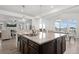 Bright kitchen with granite island, stainless steel sink, pendant lighting, and hardwood floors at 7315 Blue Water Dr, Castle Rock, CO 80108