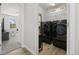 Modern laundry room with side-by-side black washer and dryer units at 7315 Blue Water Dr, Castle Rock, CO 80108