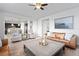 Bright and open living room with a fireplace, a comfortable sofa, and an adjacent kitchen at 7315 Blue Water Dr, Castle Rock, CO 80108