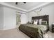 Comfortable main bedroom with a rustic wooden bed frame and ensuite bathroom access at 7315 Blue Water Dr, Castle Rock, CO 80108