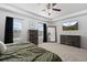 Bright main bedroom with carpet flooring, a ceiling fan, and matching dressers at 7315 Blue Water Dr, Castle Rock, CO 80108