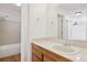 Clean bathroom with shower/tub combo, wood vanity, and beige tile at 14465 E 1St Dr # C7, Aurora, CO 80011