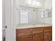 Bathroom with wood vanity, single sink, and large mirror at 14465 E 1St Dr # C7, Aurora, CO 80011