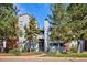 Attractive exterior of a light blue condominium building with landscaping and a walkway at 14465 E 1St Dr # C7, Aurora, CO 80011