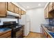 Kitchen with blue tile backsplash and wood cabinets at 14465 E 1St Dr # C7, Aurora, CO 80011