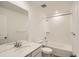 Bathroom features a tub-shower, granite countertops, tile floors, and a sink with faucet at 577 Nightsky St, Erie, CO 80516