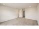 Spacious bedroom with neutral carpet, baseboard trim, recessed lighting, and multiple doors at 577 Nightsky St, Erie, CO 80516