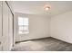 Cozy bedroom with carpet, baseboard trim, and natural light from a window at 577 Nightsky St, Erie, CO 80516