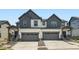 Modern townhome featuring attached garages and covered entrance at 577 Nightsky St, Erie, CO 80516