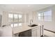 Kitchen with an island with stainless steel dishwasher and a large window at 577 Nightsky St, Erie, CO 80516