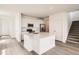 A modern kitchen with an island, stainless steel appliances, and hardwood floors at 577 Nightsky St, Erie, CO 80516