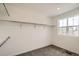 Walk-in closet with carpet and shelving, including a window for natural light at 577 Nightsky St, Erie, CO 80516
