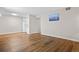 Spacious living room featuring wood flooring, a bright window, and neutral paint at 7645 E Quincy Ave # 105, Denver, CO 80237