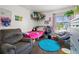 Fun bedroom features a comfortable recliner chair, a colorful rug, and a twin sized bed at 3613 S Sheridan Blvd # 10, Denver, CO 80235