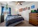 Bedroom features a ceiling fan, a dresser, and a large window that provides natural light at 3613 S Sheridan Blvd # 10, Denver, CO 80235