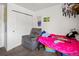 This cozy bedroom offers a recliner chair, closet, and vibrant decor that adds a unique touch at 3613 S Sheridan Blvd # 10, Denver, CO 80235