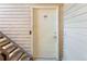 Apartment unit door number 10 with stairs on a wood-sided building at 3613 S Sheridan Blvd # 10, Denver, CO 80235