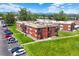 Exterior view shows a well-manicured lawn with attractive brick apartment complex and ample parking at 3613 S Sheridan Blvd # 10, Denver, CO 80235