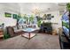 Bright living room with cozy sectional couch, fish tank and lots of plants and natural lighting at 3613 S Sheridan Blvd # 10, Denver, CO 80235