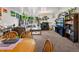 Open concept living room and dining room with big sectional couch, plants and aquarium at 3613 S Sheridan Blvd # 10, Denver, CO 80235