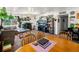 Open concept living room and dining room with big sectional couch, plants and aquarium at 3613 S Sheridan Blvd # 10, Denver, CO 80235