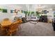 Open concept living room and dining room with big sectional couch, plants and aquarium at 3613 S Sheridan Blvd # 10, Denver, CO 80235