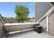 Small balcony featuring an air conditioning unit and a view of a tree and street at 5250 S Huron Way # 1-204, Littleton, CO 80120