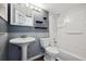 Traditional bathroom with pedestal sink, shower-tub combo, and decorative shelves at 5250 S Huron Way # 1-204, Littleton, CO 80120