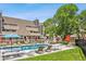 Exterior of the community pool features lounge seating and well-maintained grassy area at 5250 S Huron Way # 1-204, Littleton, CO 80120
