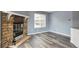 Living room features a stone fireplace and a window with natural light at 5250 S Huron Way # 1-204, Littleton, CO 80120