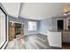 Living room boasts a stone fireplace, hardwood floors and a large window at 5250 S Huron Way # 1-204, Littleton, CO 80120