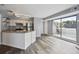 Living room boasts a stainless steel refrigerator, stone countertop and access to a private patio at 5250 S Huron Way # 1-204, Littleton, CO 80120