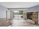 Open floor plan with a stone fireplace and a sliding glass door to the outdoor patio at 5250 S Huron Way # 1-204, Littleton, CO 80120