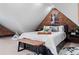 Spacious attic bedroom with exposed brick wall and stylish decor at 885 S Sherman St, Denver, CO 80209