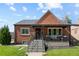 Brick house with a covered porch and well-maintained lawn at 885 S Sherman St, Denver, CO 80209