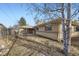 View of backyard with grass and brick exterior, covered patio, and decorative fountain at 1495 S Chase Ct, Lakewood, CO 80232