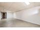 Spacious unfinished basement with neutral flooring, light walls, and door at 1495 S Chase Ct, Lakewood, CO 80232